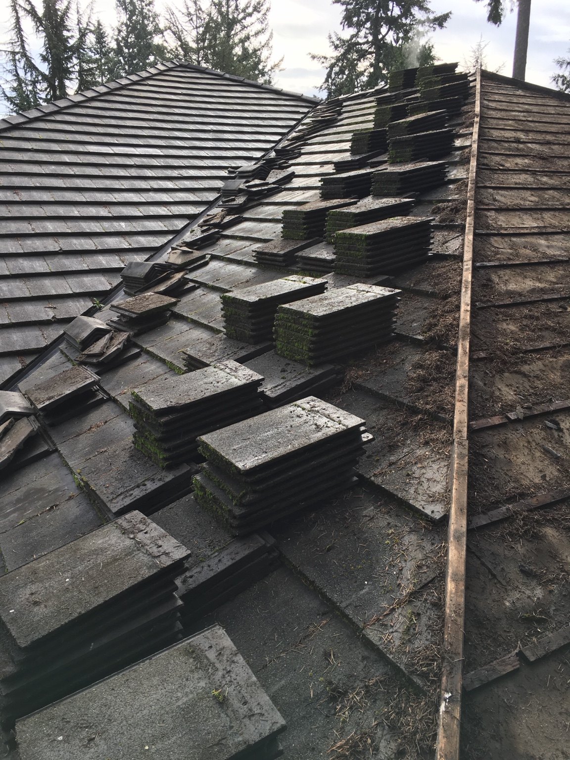 Roofing work in progress with sections of the roof exposed